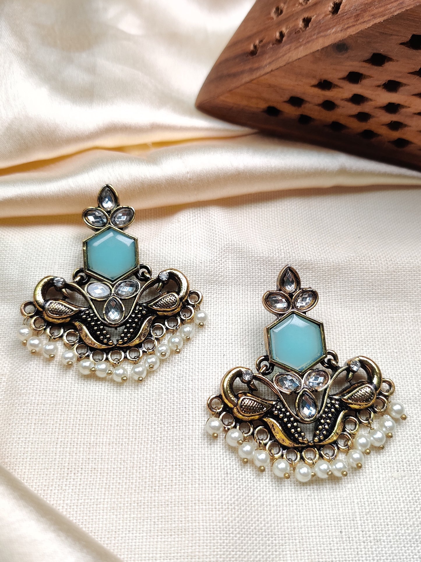 Golden peacock earrings with blue stone & pearl drops