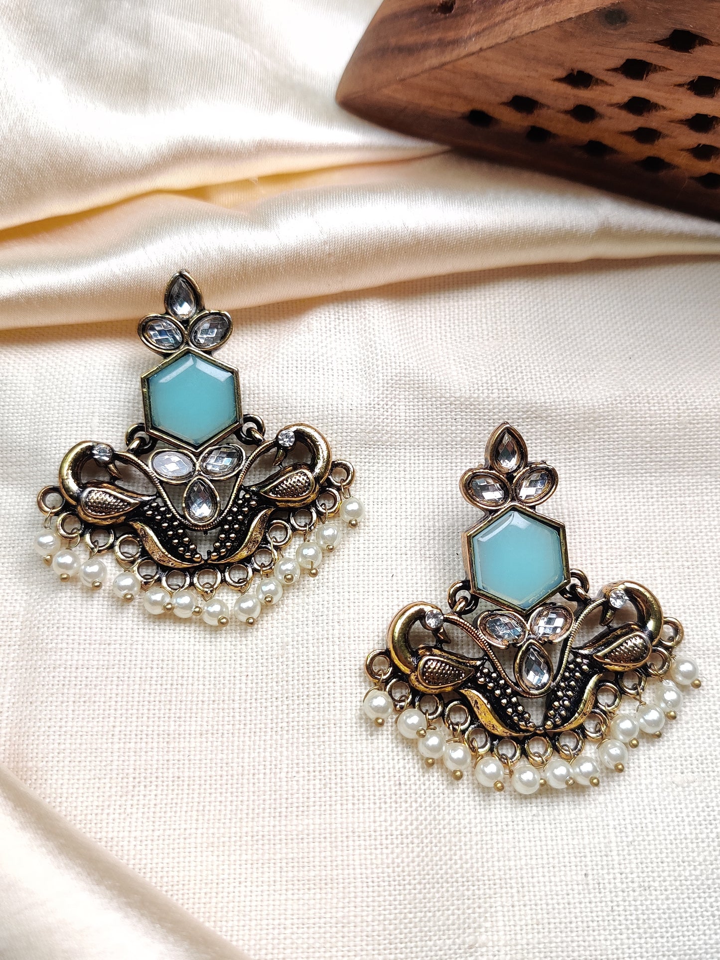 Golden peacock earrings with blue stone & pearl drops